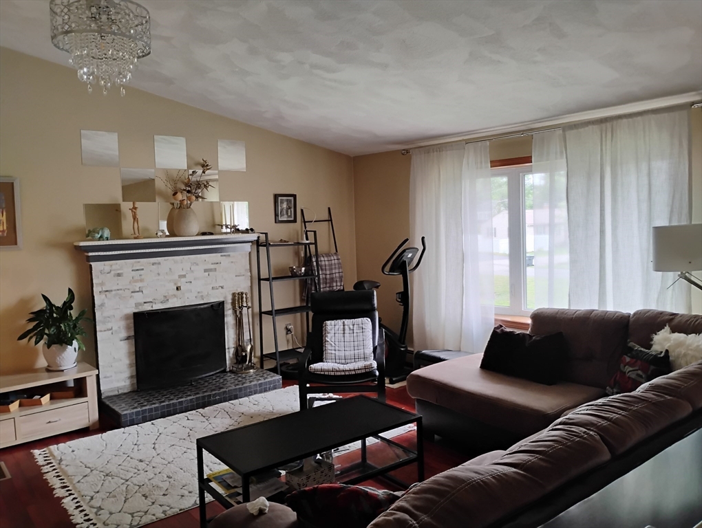 9 Packard Road Milford, MA 01757 - Photo 8 of 30 a living room with furniture and a fireplace