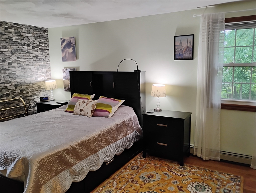 9 Packard Road Milford, MA 01757 - Photo 10 of 30 a bedroom with a bed and a lamp