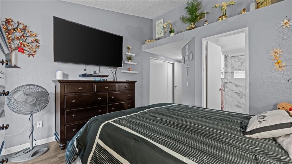 12846 Mayflower Court Riverside, CA 92503 - Photo 16 of 32 a bedroom with a bed and a flat tv screen on dresser