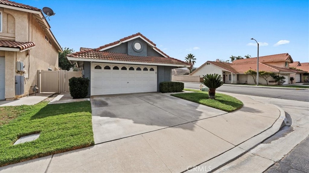 12846 Mayflower Court Riverside, CA 92503 - Photo 2 of 32 a front view of a house with a yard and potted plants