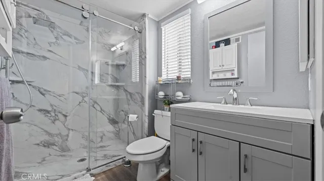 a bathroom with a sink toilet and shower