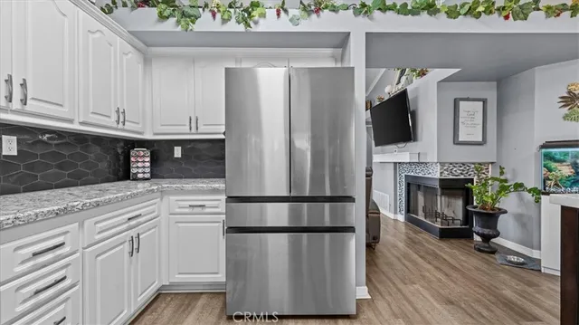 a kitchen with a refrigerator and a stove top oven