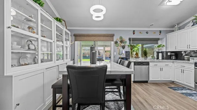 a kitchen with stainless steel appliances granite countertop a white cabinets and a stove
