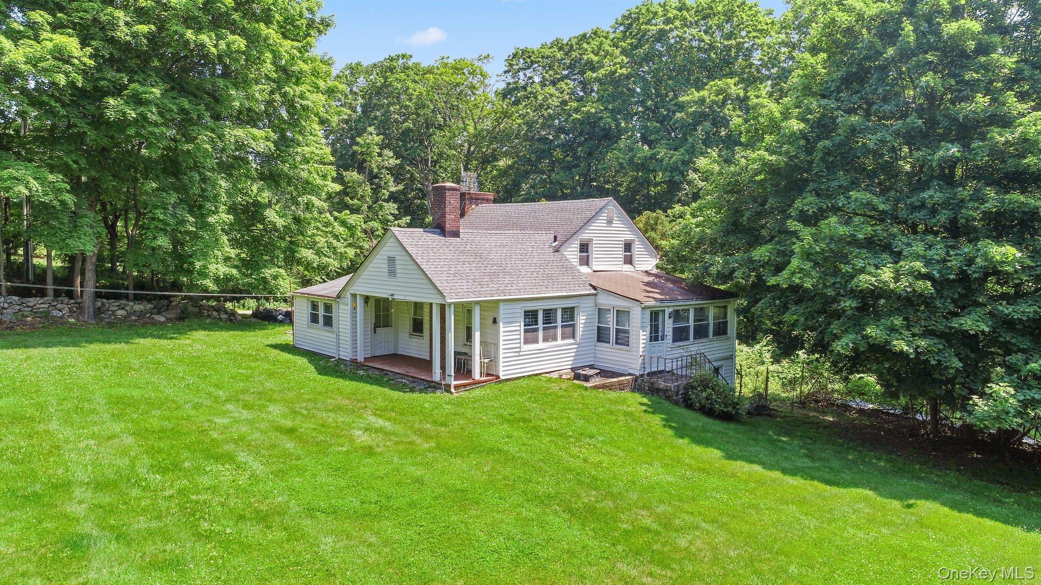 3868 Indian Hill Road Shrub Oak, NY 10588 - Photo 9 of 33 a view of a house with a big yard plants and large trees