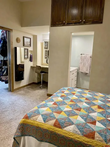a bedroom with a bed and a dresser