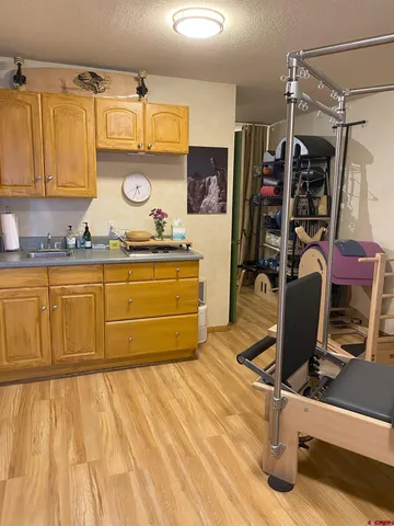 a view of a kitchen with wooden floor and chair