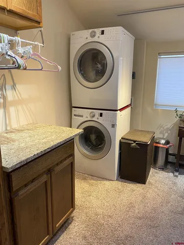 a utility room with sink dryer and washer