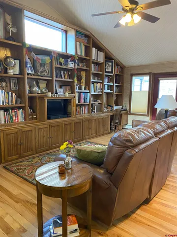 a living room with furniture and a book shelf
