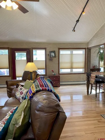 a bedroom with furniture and a wooden floor