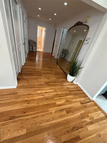 a view of entryway and hall with wooden floor