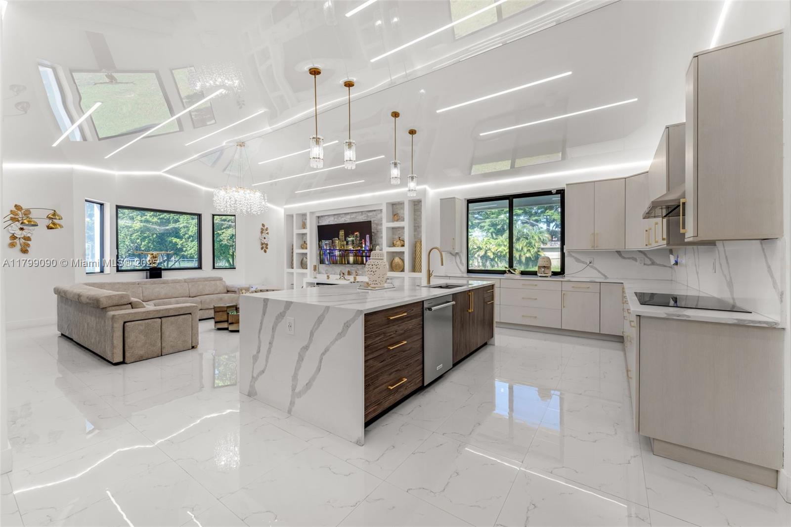 17795 Southwest 158th Street Miami, FL 33187 - Photo 11 of 45 a large white kitchen with a large window and stainless steel appliances