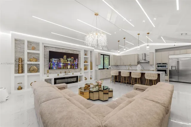 a living room with furniture and kitchen view