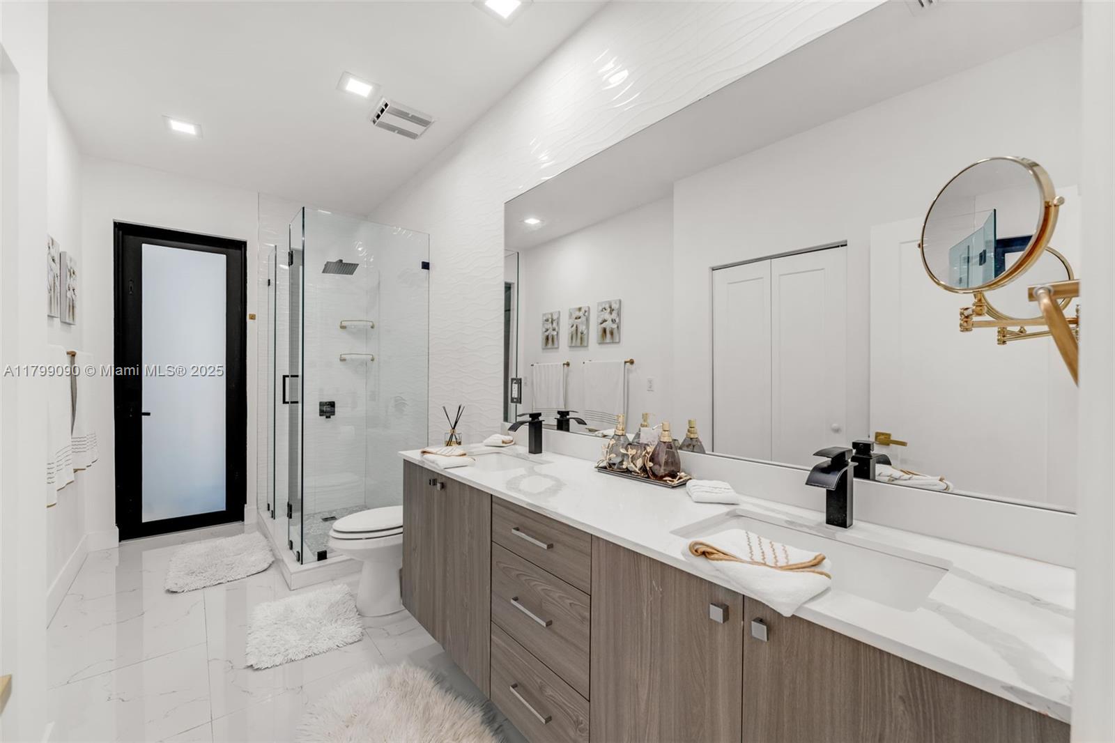 17795 Southwest 158th Street Miami, FL 33187 - Photo 17 of 45 a bathroom with a double vanity sink mirror and toilet