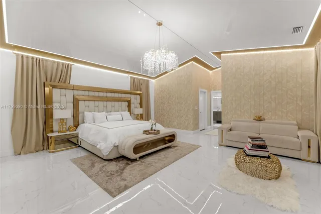 a spacious bedroom with a bed a chandelier and a large mirror on the dresser