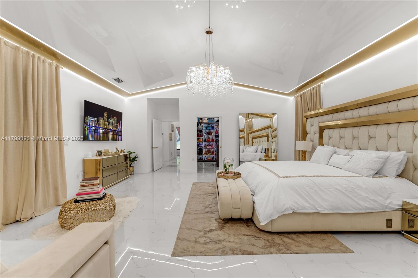 17795 Southwest 158th Street Miami, FL 33187 - Photo 20 of 45 a bedroom with a large bed and a chandelier