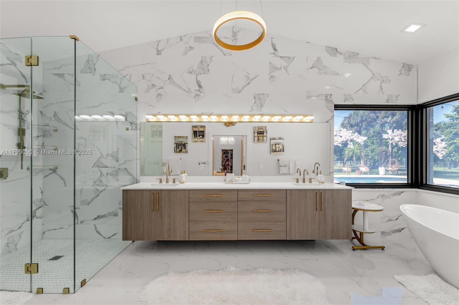 17795 Southwest 158th Street Miami, FL 33187 - Photo 22 of 45 a bathroom with a double vanity sink a large mirror and a bathtub