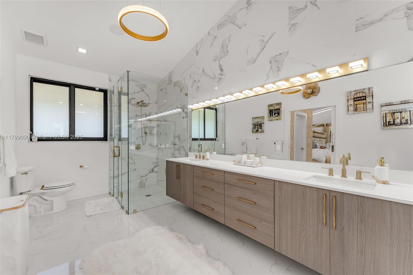 17795 Southwest 158th Street Miami, FL 33187 - Photo 23 of 45 a spacious bathroom with a double vanity sink toilet mirror and bathtub