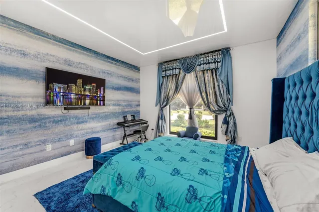 a spacious bedroom with a bed and a window