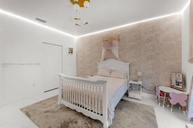 a bedroom with a bed and a mirror