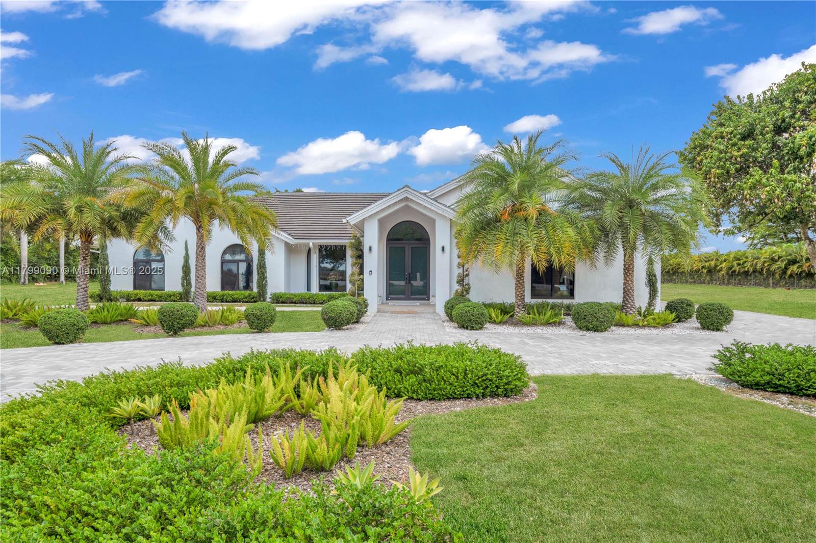 17795 Southwest 158th Street Miami, FL 33187 - Photo 3 of 45 a front view of a house with a garden