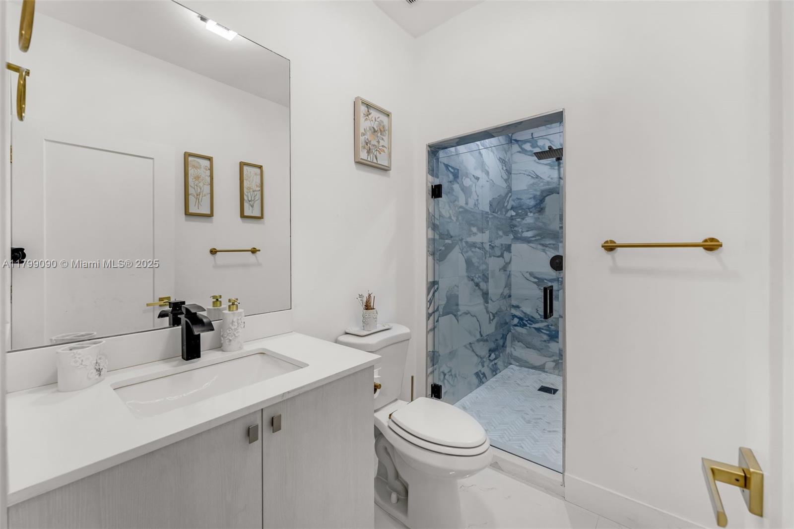 17795 Southwest 158th Street Miami, FL 33187 - Photo 32 of 45 a bathroom with a sink a toilet and shower