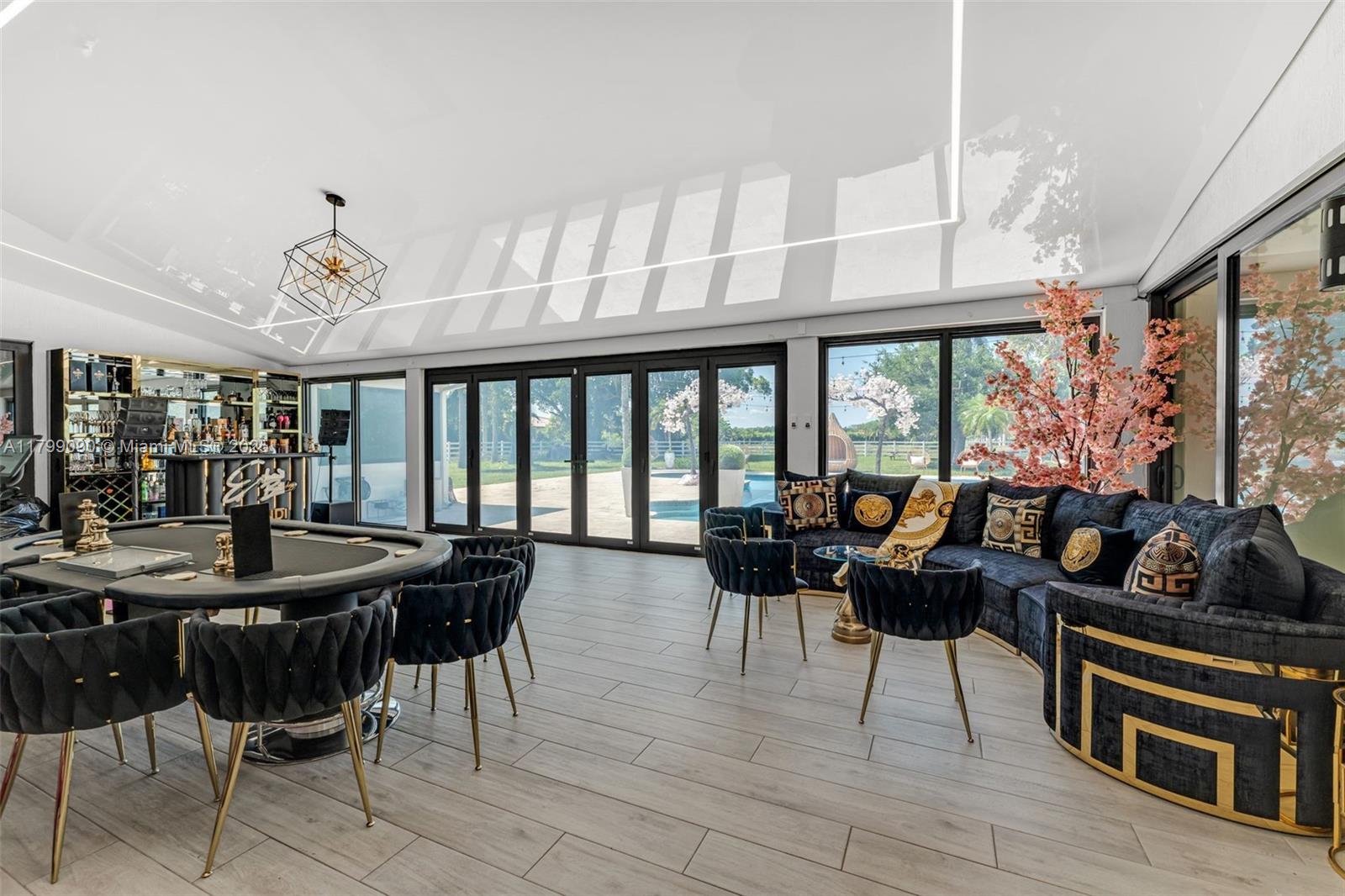17795 Southwest 158th Street Miami, FL 33187 - Photo 33 of 45 a view of a dining room with furniture large windows and wooden floor