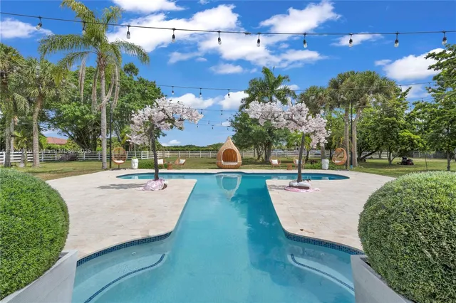 a view of a swimming pool with an outdoor space and seating area