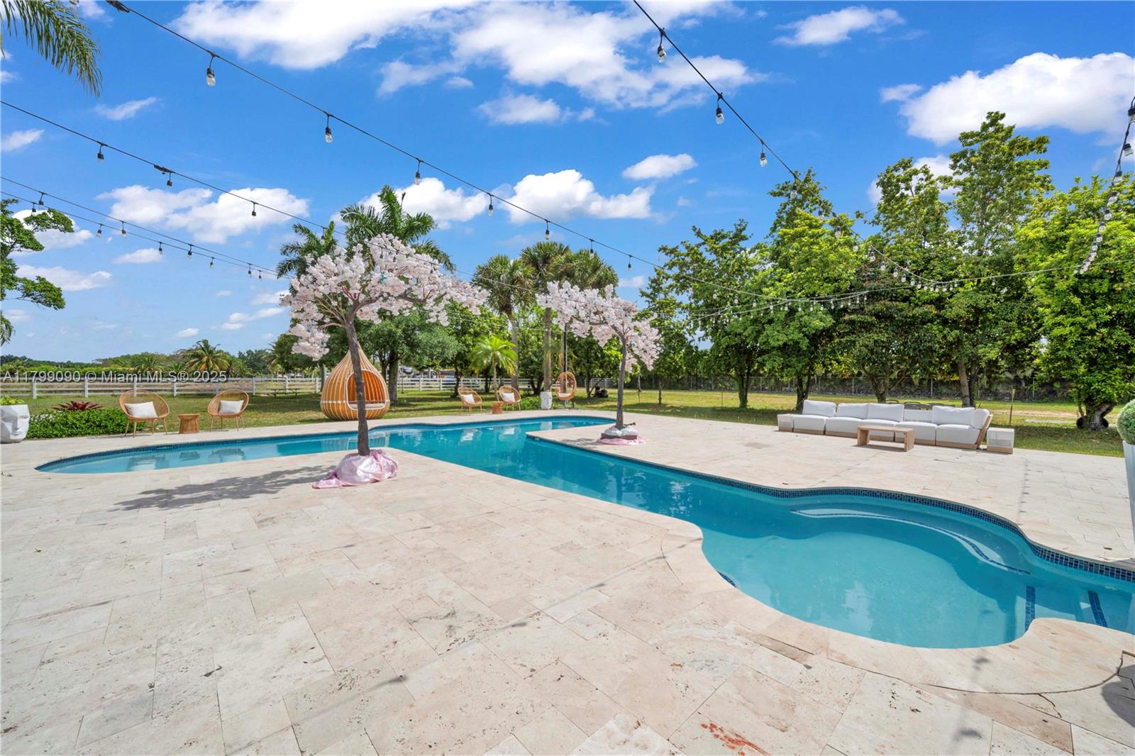 17795 Southwest 158th Street Miami, FL 33187 - Photo 38 of 45 a view of a swimming pool with an outdoor space and seating area