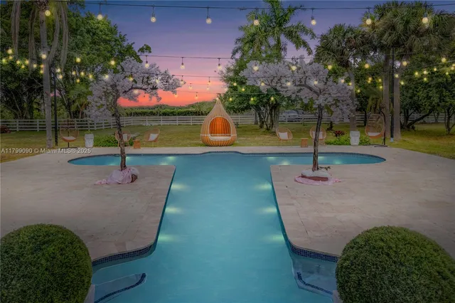 a view of a swimming pool with an outdoor space and seating area