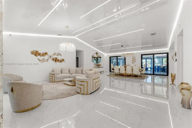 a living room with furniture a rug and a chandelier