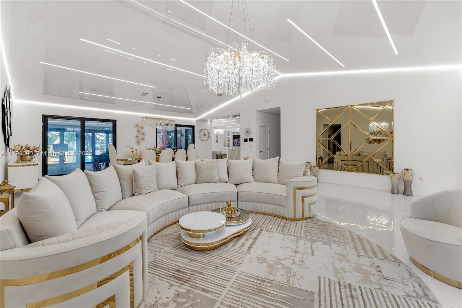 17795 Southwest 158th Street Miami, FL 33187 - Photo 7 of 45 a living room with furniture a rug and a chandelier