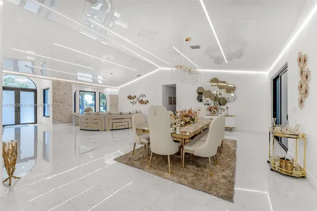 a kitchen with stainless steel appliances kitchen island granite countertop a stove and white cabinets