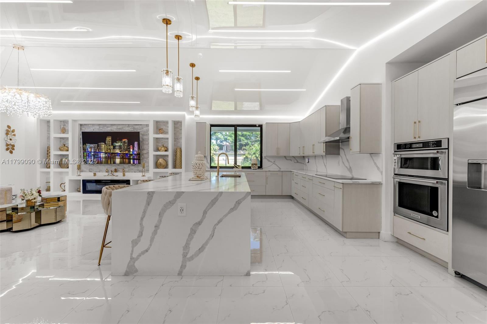 17795 Southwest 158th Street Miami, FL 33187 - Photo 10 of 45 a kitchen with stainless steel appliances kitchen island granite countertop a stove and white cabinets