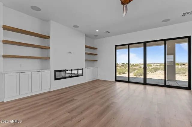a kitchen with kitchen island a center island a stove a wooden floor and window