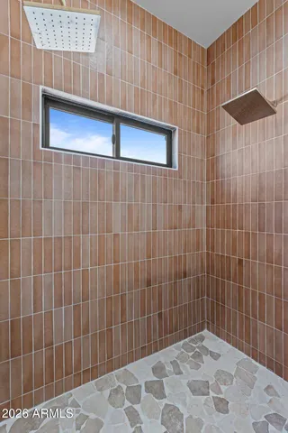 a bathroom with a double vanity sink and a mirror