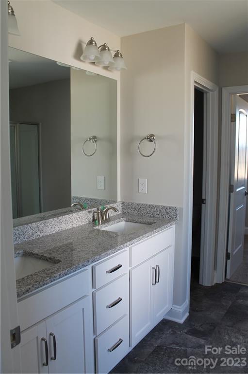 3224 Austin Chaney Road Monroe, NC 28110 - Photo 12 of 23 a bathroom with a granite countertop sink and a mirror