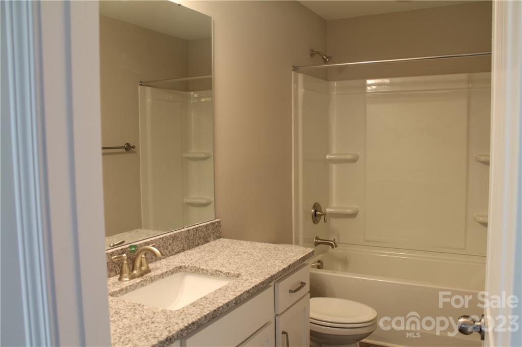 3224 Austin Chaney Road Monroe, NC 28110 - Photo 21 of 23 a bathroom with a granite countertop sink toilet and shower