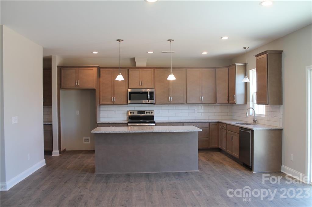 3224 Austin Chaney Road Monroe, NC 28110 - Photo 6 of 23 a large kitchen with stainless steel appliances kitchen island a large counter top and a sink