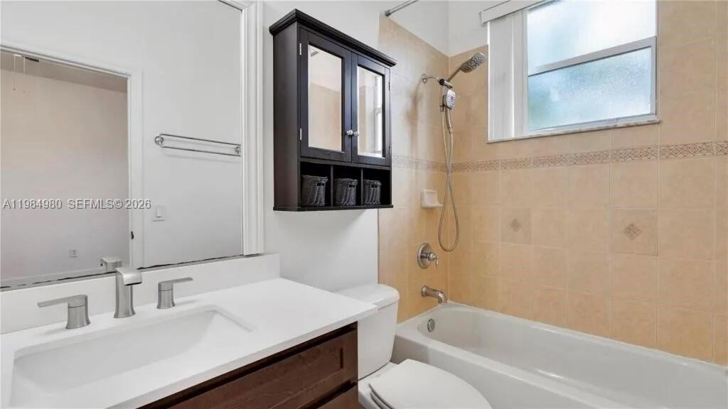 4921 Southwest 140th Terrace, Unit 1 Miramar, FL 33027 - Photo 11 of 16 a bathroom with a sink vanity toilet and tub
