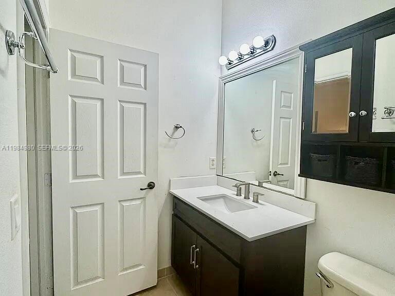 4921 Southwest 140th Terrace, Unit 1 Miramar, FL 33027 - Photo 12 of 16 a bathroom with a sink vanity granite and a mirror