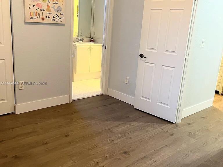 4921 Southwest 140th Terrace, Unit 1 Miramar, FL 33027 - Photo 13 of 16 an empty room with wooden floor and windows