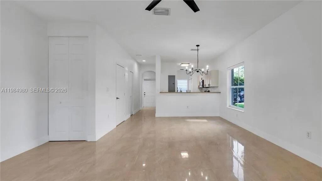 4921 Southwest 140th Terrace, Unit 1 Miramar, FL 33027 - Photo 3 of 16 wooden floor in an empty room with a kitchen