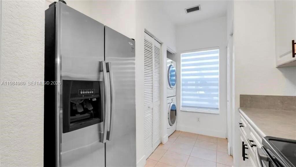 4921 Southwest 140th Terrace, Unit 1 Miramar, FL 33027 - Photo 5 of 16 a kitchen with a refrigerator and white cabinets