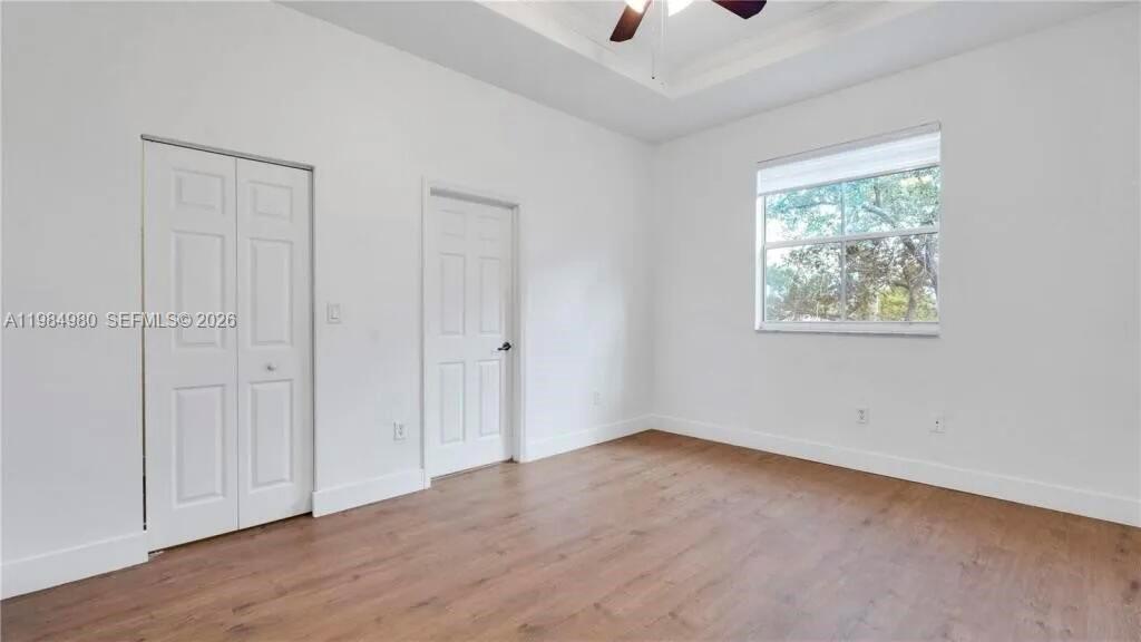 4921 Southwest 140th Terrace, Unit 1 Miramar, FL 33027 - Photo 8 of 16 wooden floor in an empty room with a window
