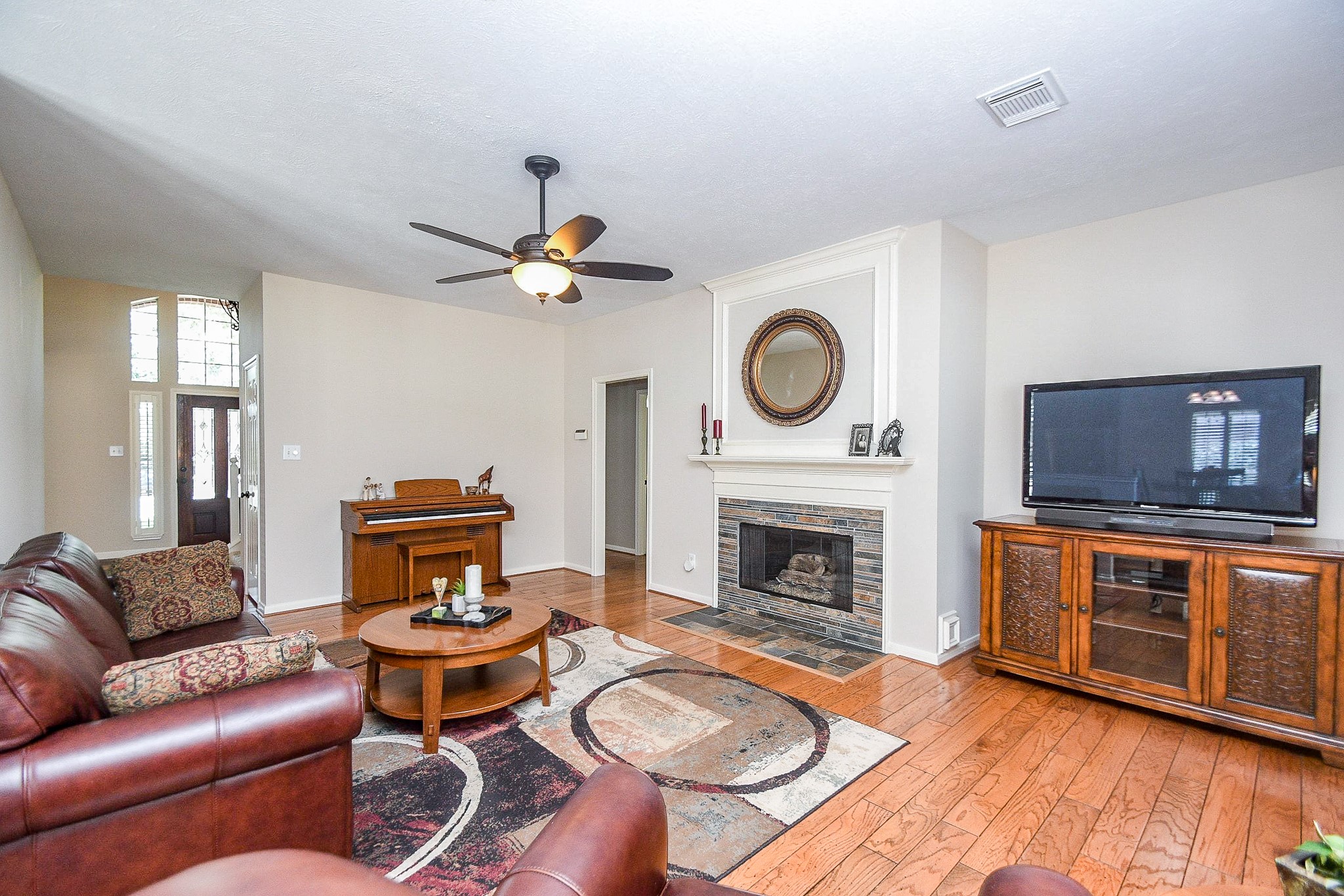 1703 Fall Ridge Circle Katy, TX 77494 - Photo 7 of 38 The den features a gas-log fireplace and a large niche for your TV. The doorway leads to a secondary bedroom, a FULL bathroom, and the laundry room.