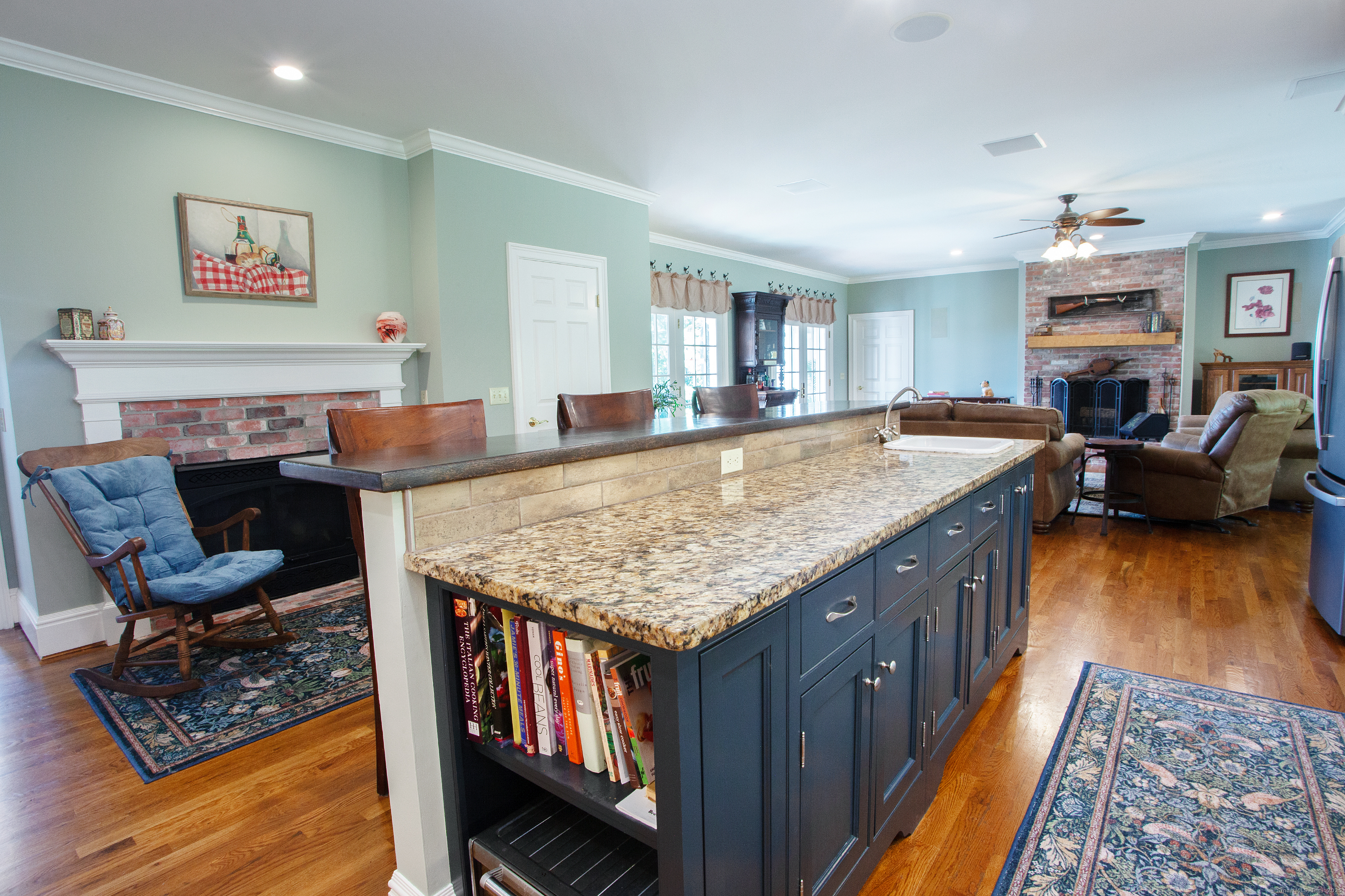 15 Old Orchard Road Granby, CT 06090 - Photo 10 of 32 The center island and gas fireplace behind offer a space for family and friends to gather.