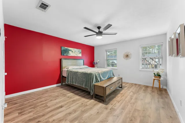 a bedroom with a bed and a chandelier