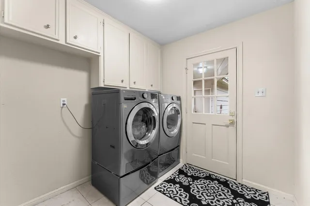 a living room with patio furniture and a potted plant