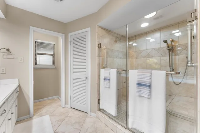 a bathroom with a shower and a sink