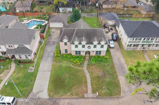 an aerial view of houses with outdoor space